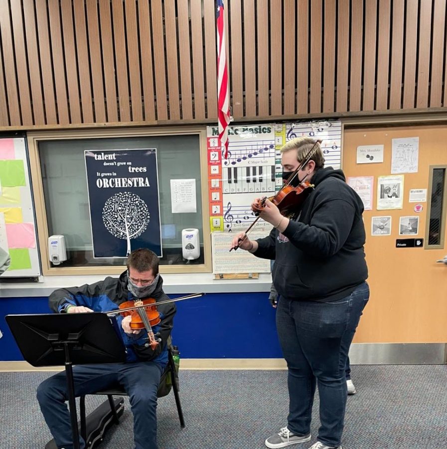 Matthew mentors new musician Damian on how to play the violin.