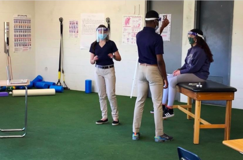 Sarah Mandelkow (left) and Kerann Belvu (middle) perform a concussion analysis on a fellow student, during the SkillsUSA regional competition. 